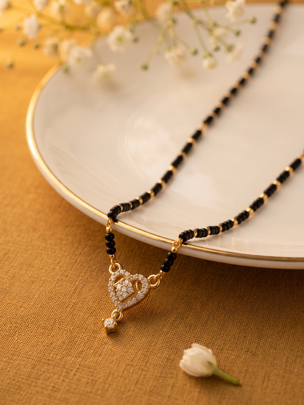 lfariya jewellery contemporary Indian mangalsutra necklace with a classic square gemstone pendant, rich gold plated detailing, black bead chain and premium ethnic craftsmanship for modern women