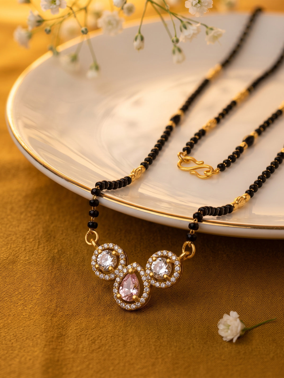 lfariya jewellery fashionable gold plated mangalsutra featuring a classic square pendant with a rich red gemstone, crystal border and lightweight black bead chain for women.