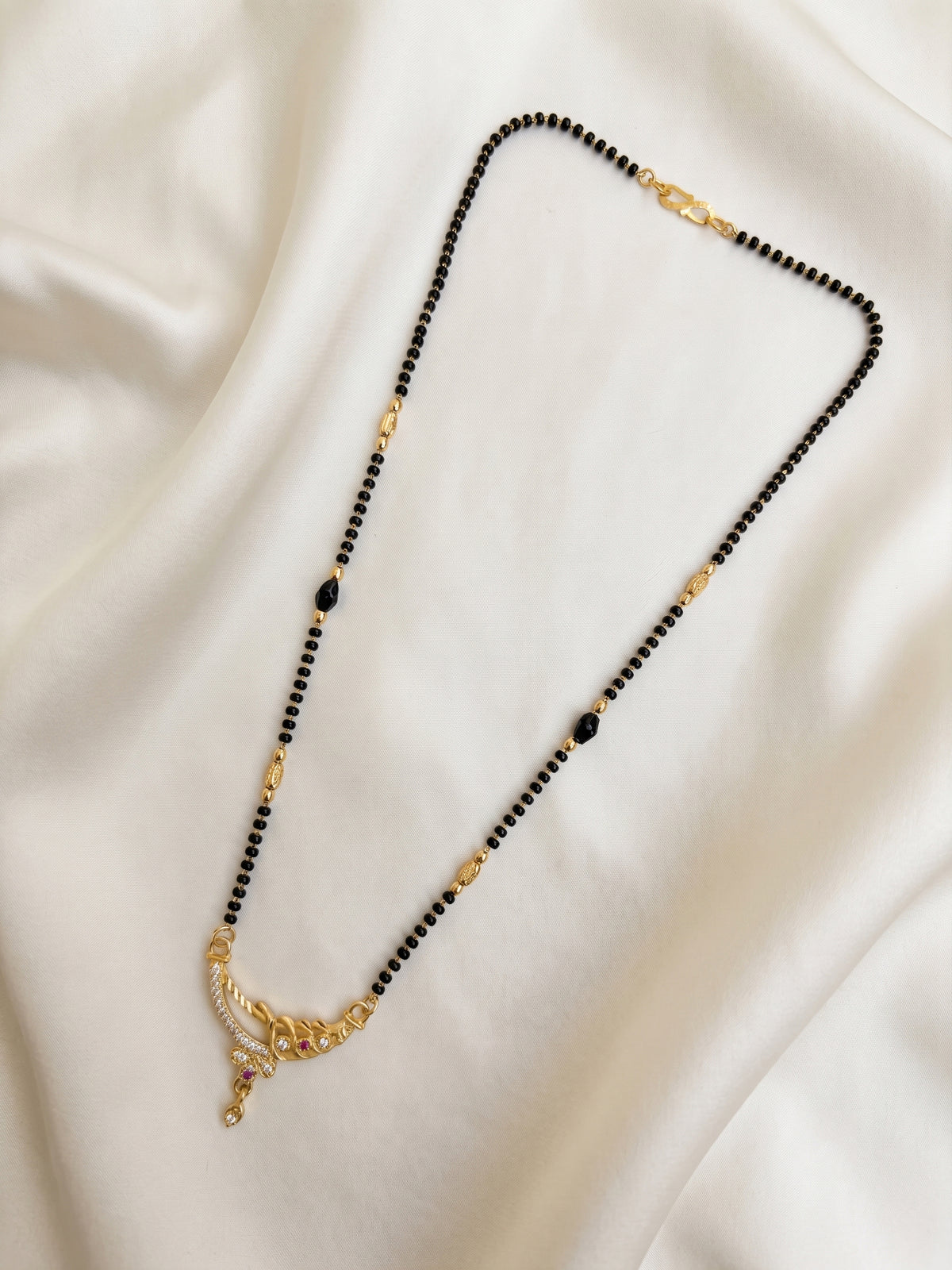 lfariya jewellery gold plated mangalsutra necklace featuring a square ruby red gemstone pendant with sparkling crystal halo, elegant black bead chain, premium craftsmanship for women, perfect for daily and festive wear.