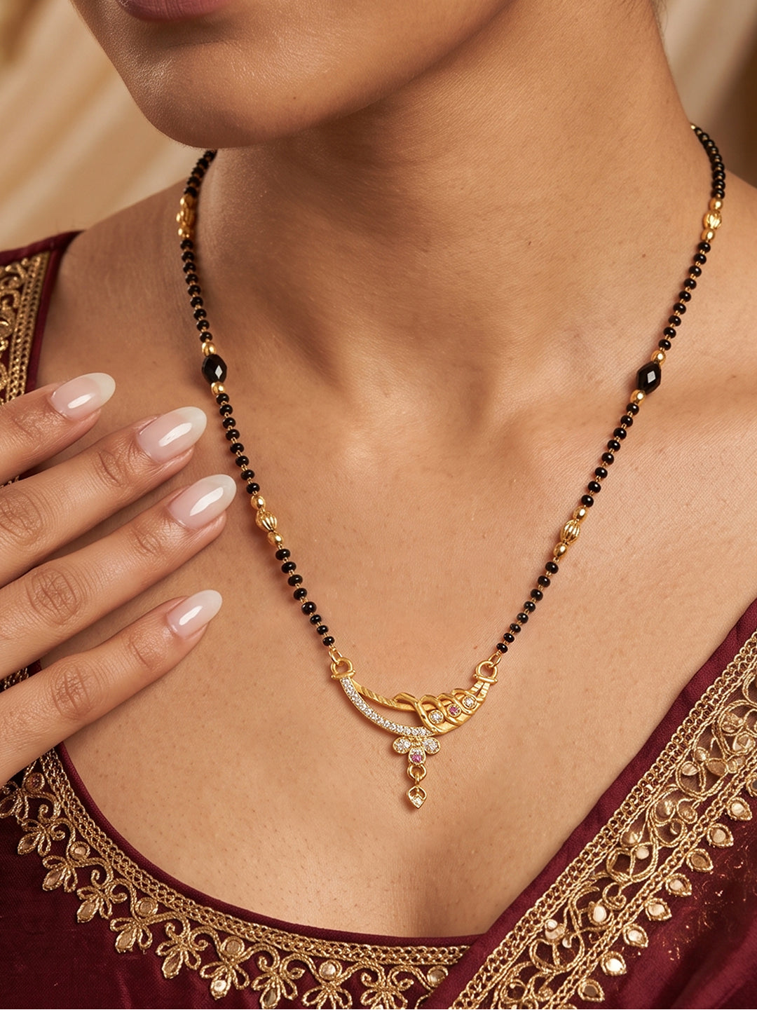 Lfariya Jewellery Royal Harmony CZ Gold Plated Mangalsutra with elegant curved pendant, black bead chain and sparkling cubic zirconia stones.