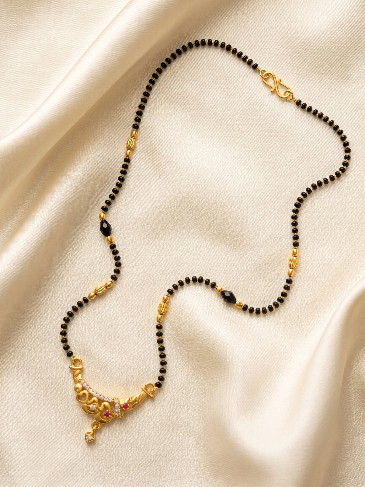 lfariya jewellery designer gold plated mangalsutra featuring a brilliant square pendant with a rich red gemstone, crystal accents and lightweight black bead chain for women.