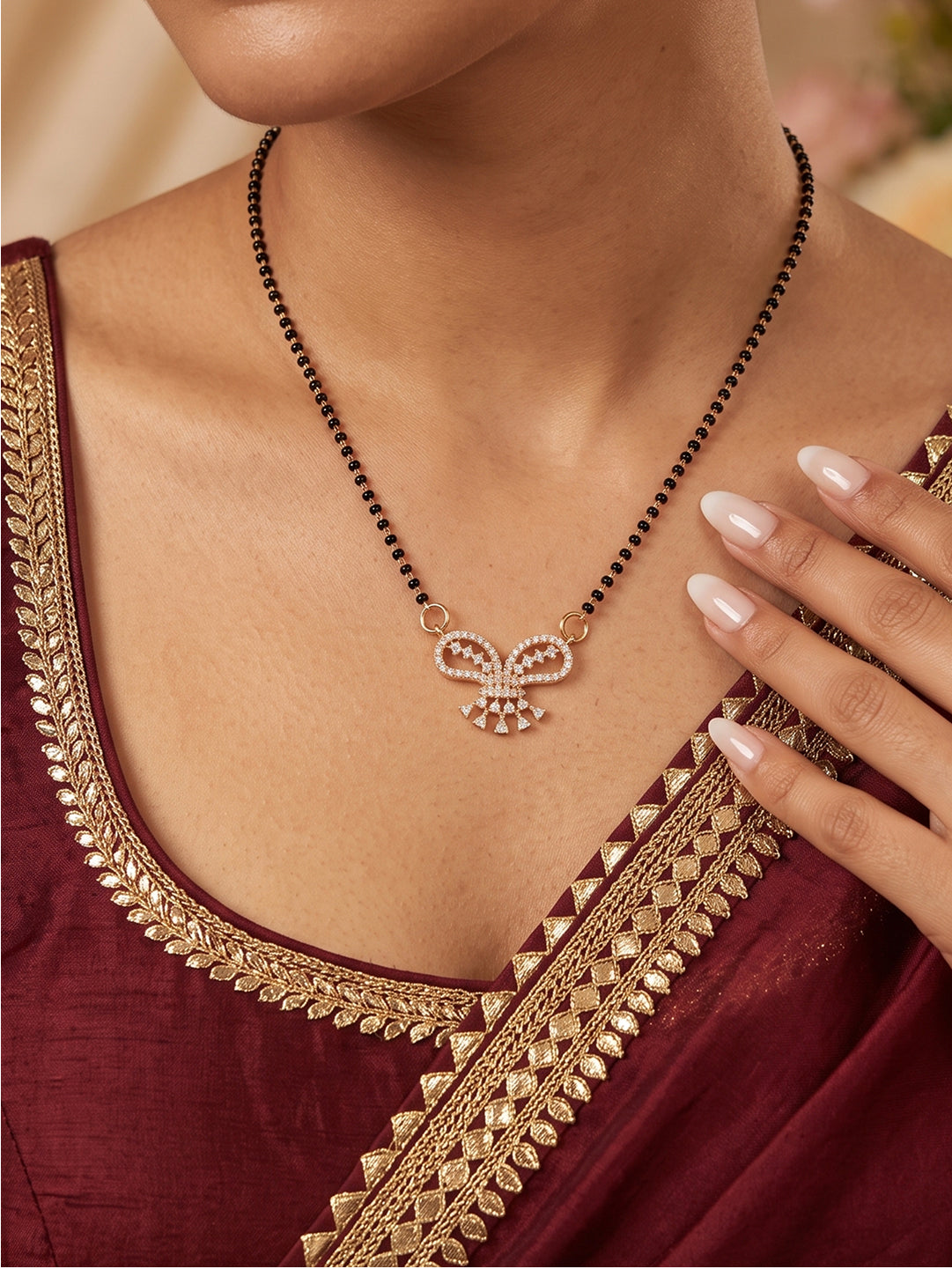 Gold plated bow shape CZ mangalsutra necklace with black bead chain for women.