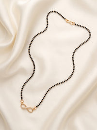 lfariya jewellery graceful black bead mangalsutra with a luxurious square pendant, vibrant gemstone center and polished gold plated craftsmanship