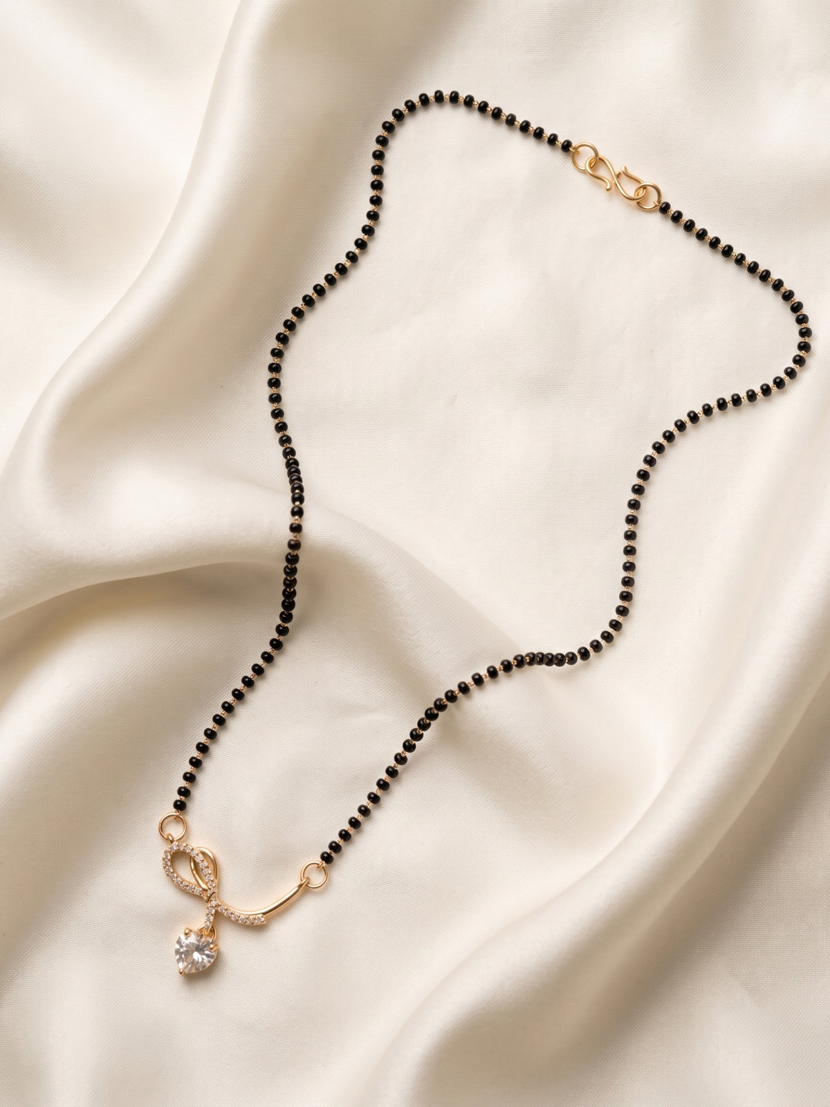 lfariya jewellery designer gold plated mangalsutra featuring a brilliant ruby gemstone pendant, elegant black bead chain and timeless jewelry styling for women, ideal for festive and bridal wear