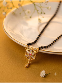 lfariya jewellery premium women's mangalsutra with a radiant square red gemstone pendant, polished gold plated design, traditional black bead chain and elegant styling for daily wear, weddings and festive occasions.