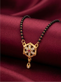lfariya jewellery elegant gold plated mangalsutra necklace displayed on a luxury white ceramic plate, featuring a square ruby gemstone pendant, sparkling stone detailing, black bead chain and premium handcrafted finish for women.