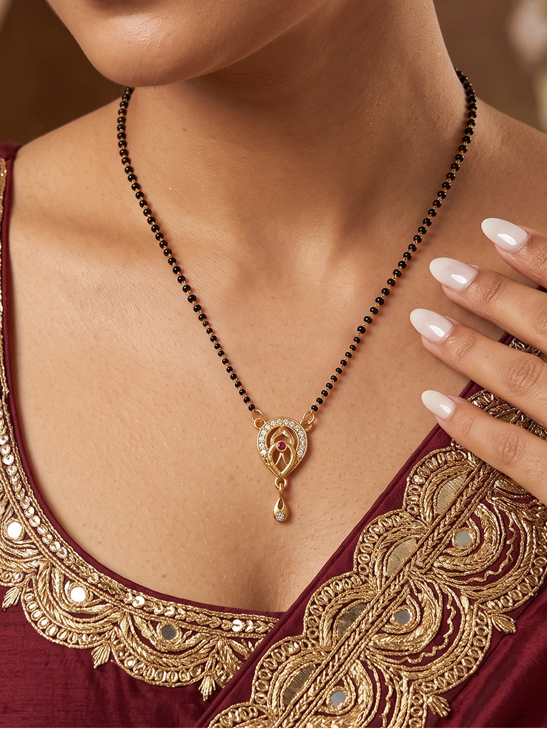 Elegant gold-tone mangalsutra pendant necklace with leaf-shaped CZ design and drop charm, perfect for Indian women, festive wear, weddings, and daily traditional styling.