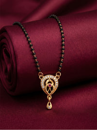 lfariya jewellery beautifully crafted gold plated necklace featuring a sparkling square pendant, vibrant gemstone center and elegant black bead chain displayed on a decorative ceramic plate