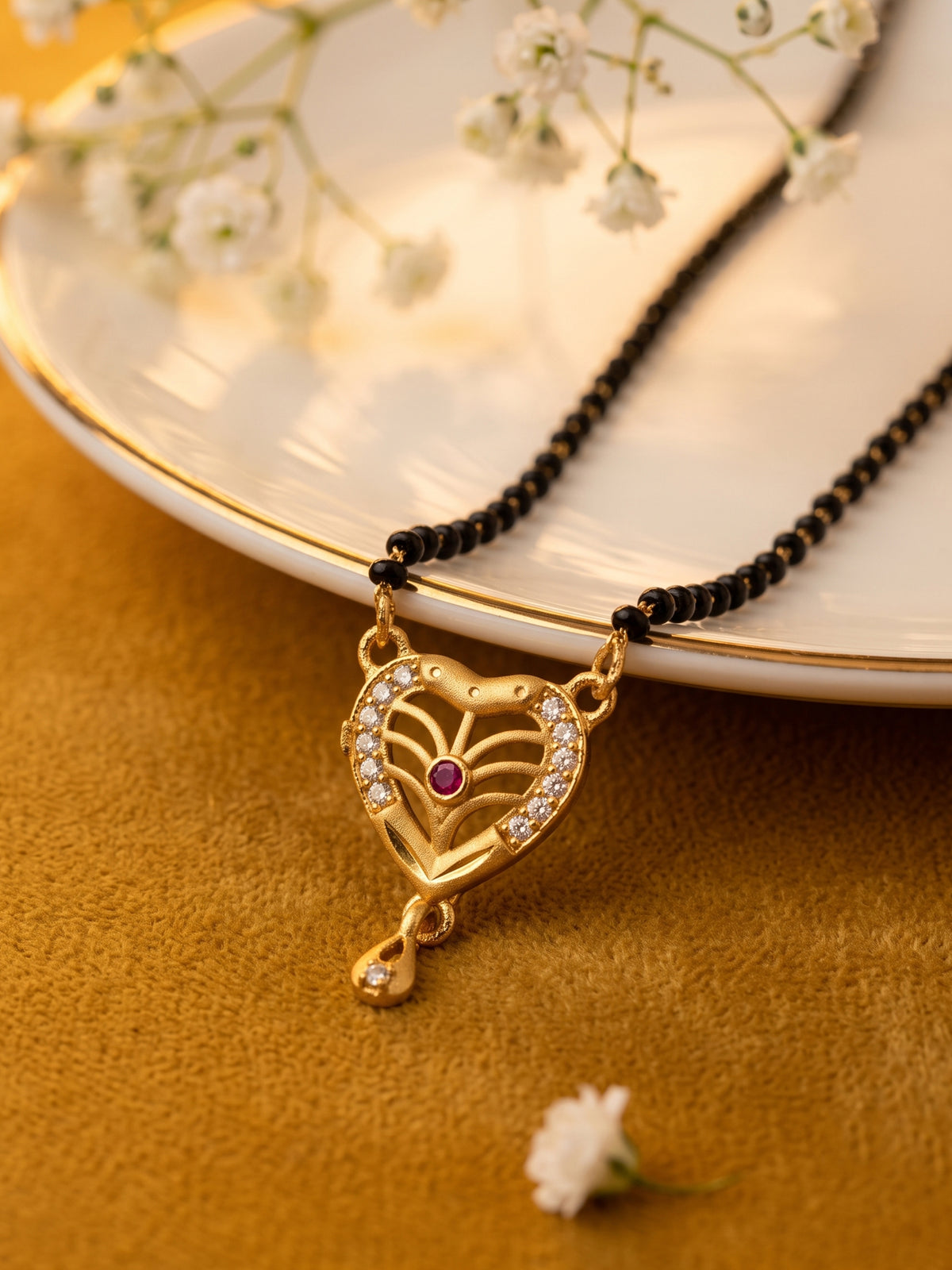lfariya jewellery Indian designer mangalsutra featuring a beautiful square red stone pendant, gold plated finish and classic black bead chain for women.