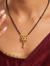 Elegant lotus flower gold plated mangalsutra pendant with sparkling CZ stones, black bead chain and drop charm for women, suitable for weddings, festivals and daily wear.