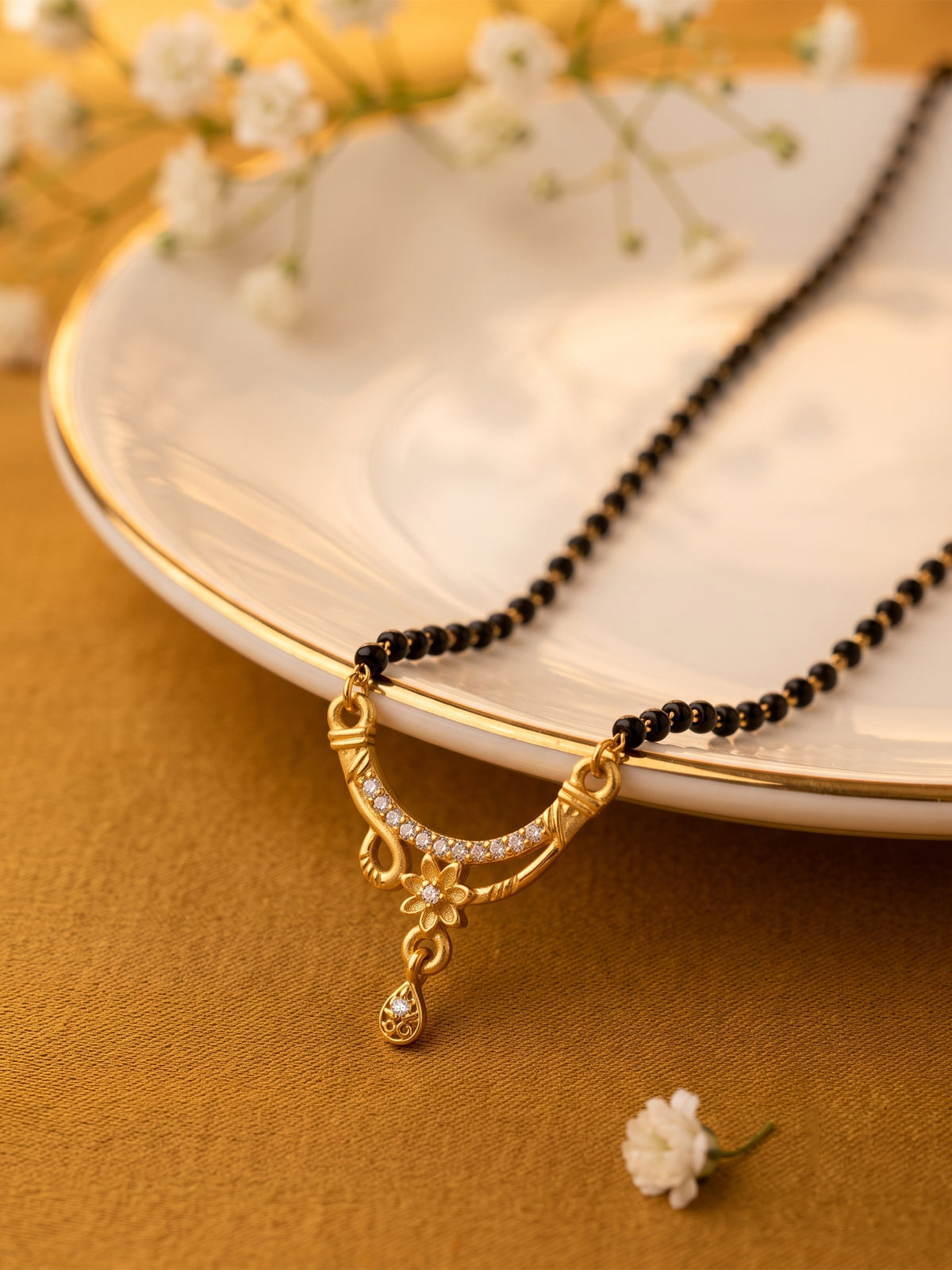 lfariya jewellery stylish Indian mangalsutra necklace with a geometric ruby stone pendant, elegant black bead chain and luxurious gold plated craftsmanship.