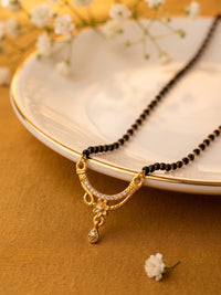 lfariya jewellery stylish Indian mangalsutra necklace with a geometric ruby stone pendant, elegant black bead chain and luxurious gold plated craftsmanship.