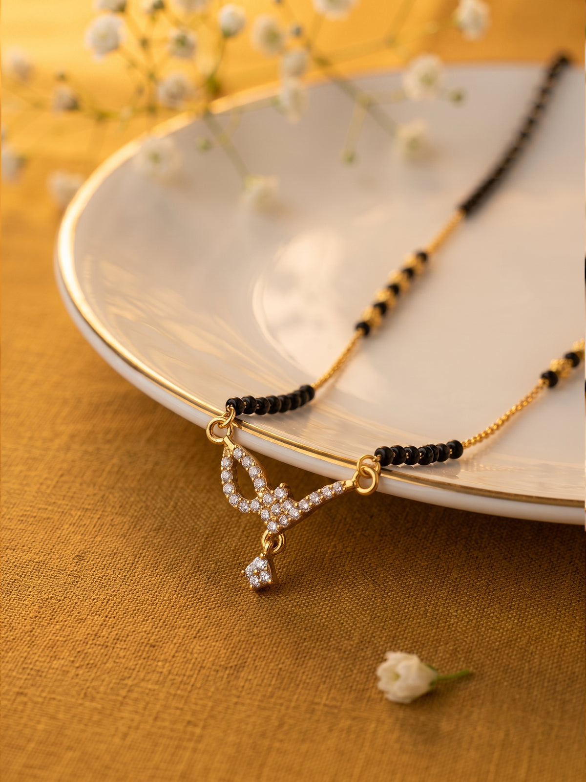 lfariya jewellery elegant bridal mangalsutra necklace with a square gemstone pendant, polished gold plated finish and traditional black bead chain for every occasion.