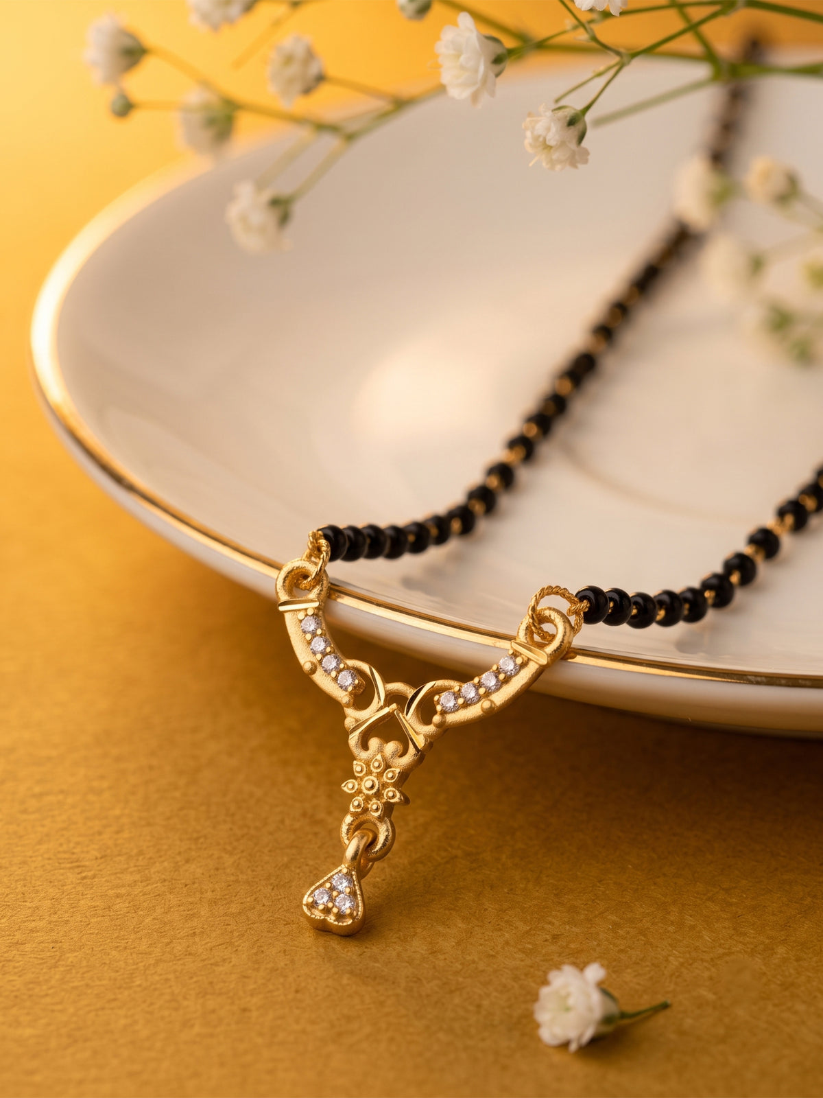 lfariya jewellery designer mangalsutra necklace inspired by Indian heritage with a square ruby pendant, gold plated finish and graceful black bead chain.