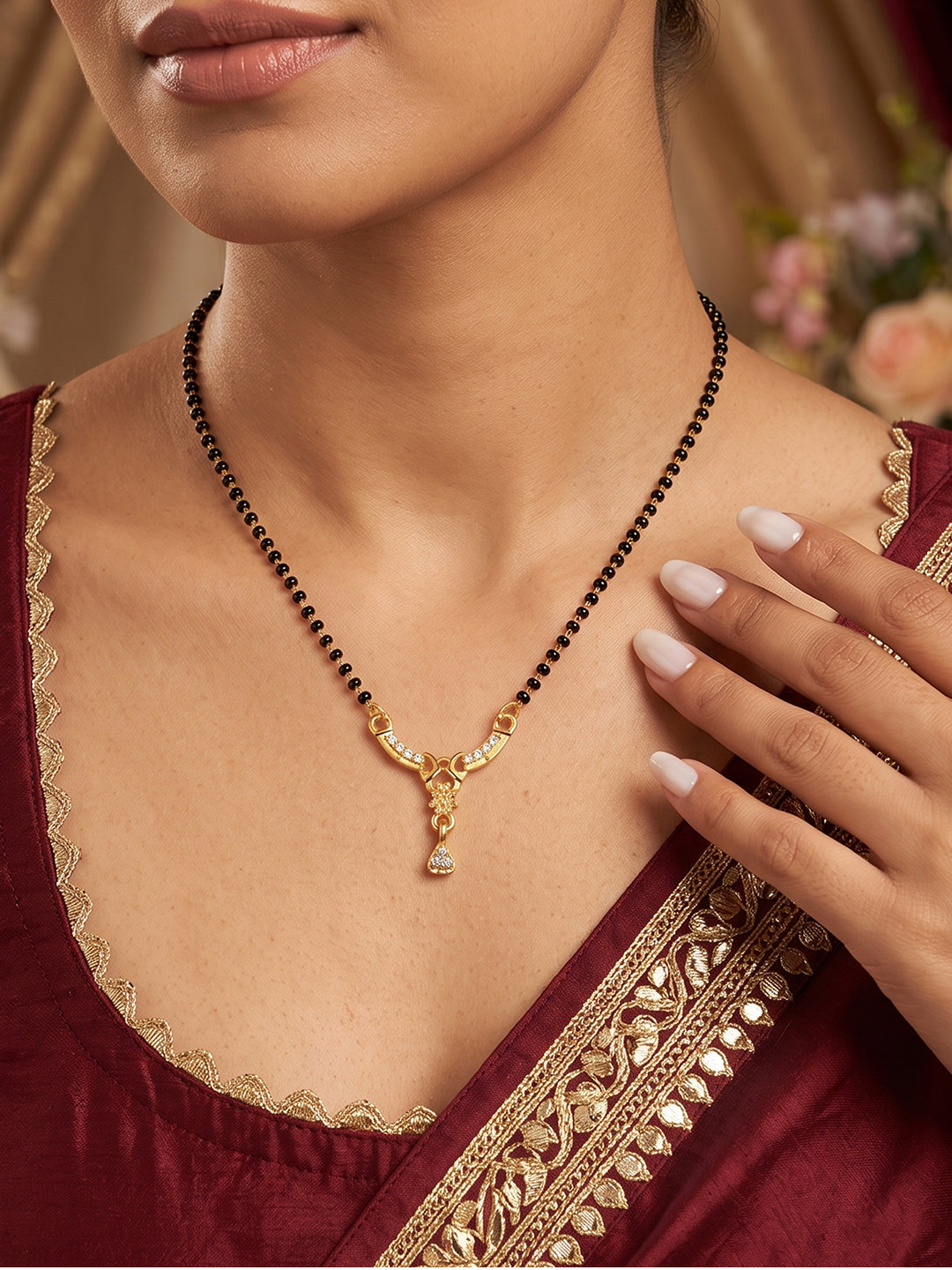 Enhance your traditional look with the Royal Arc Spark Mangalsutra by Lfariya Jewellery. Designed with a graceful curved CZ-studded pendant, black bead chain, and sparkling teardrop charm, this lightweight mangalsutra is perfect for daily wear, weddings, festive occasions, and gifting.