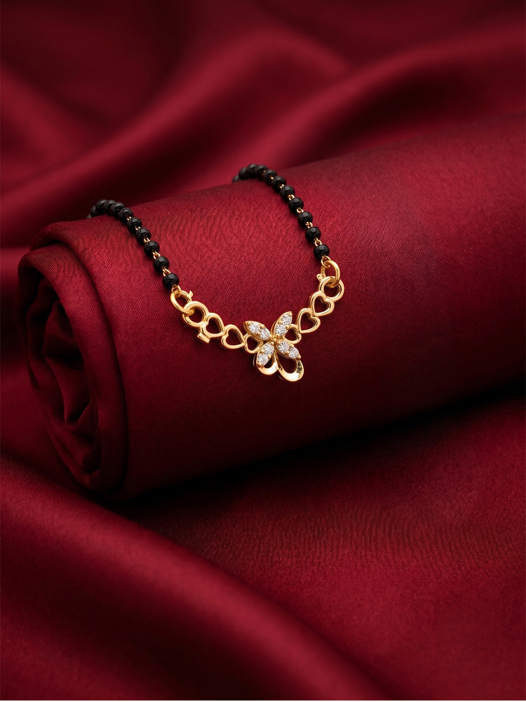 lfariya jewellery premium designer mangalsutra featuring a vibrant red gemstone pendant, polished gold plated finish and classic black bead chain for Indian ethnic fashion.