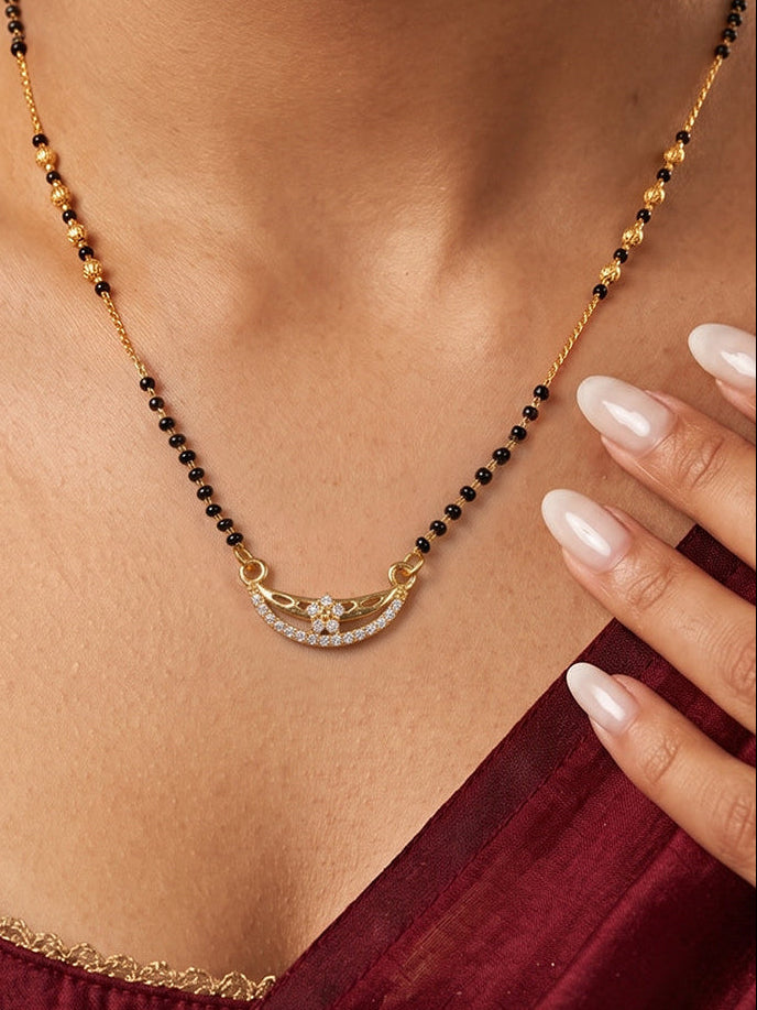 Celestial Bloom Curve Mangalsutra by Lfariya Jewellery featuring a curved CZ floral pendant with black beads and gold-tone chain for elegant daily wear.