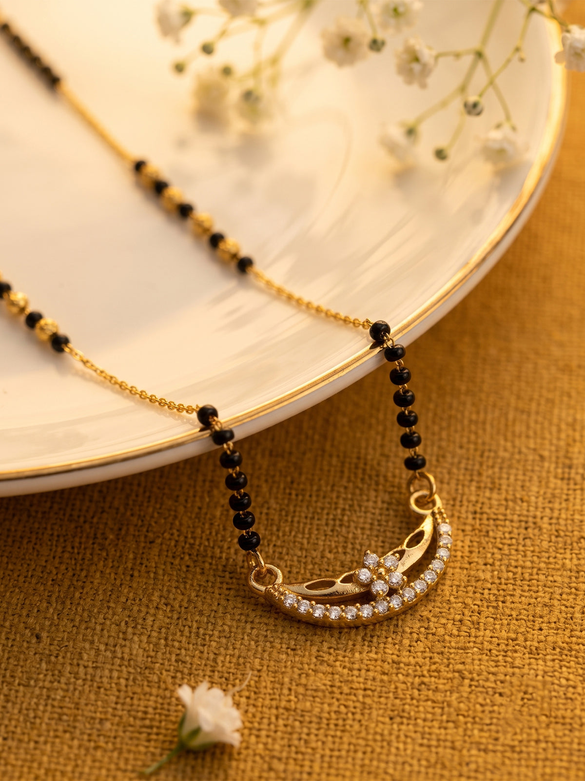 lfariya jewellery exclusive bridal mangalsutra with a polished square gemstone pendant, black bead chain and luxurious gold plated finish inspired by Indian traditions.